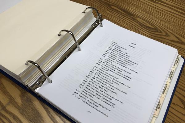 Inyo County Code Book open on table to Title 18