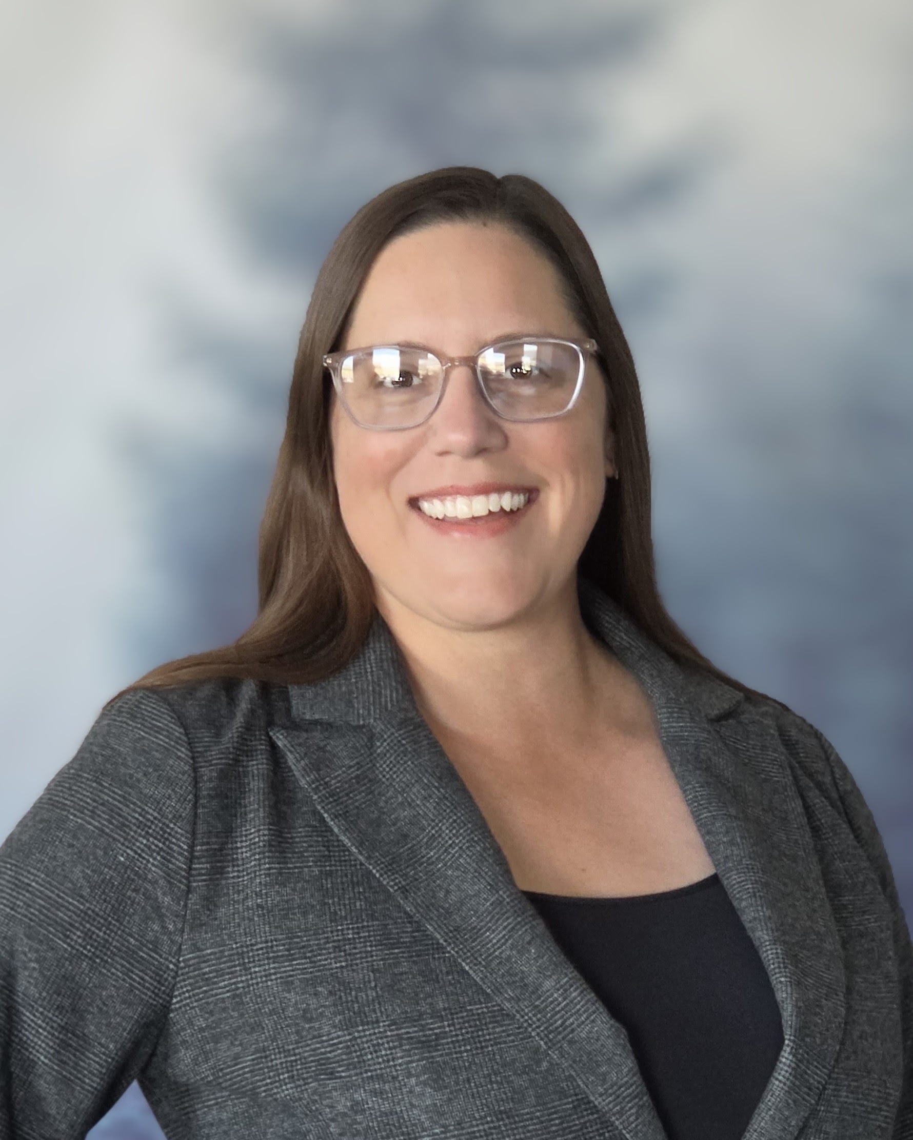 photo of a woman with brown hair and glasses
