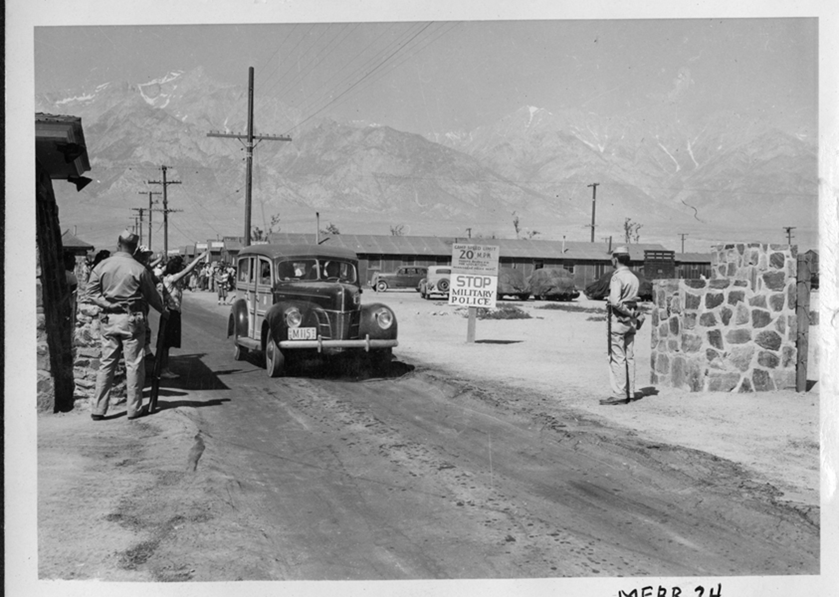 Armed guards at the main gate to the Manzanar War Relocation Center.