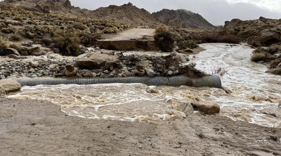 Dirt road washed out by flooding.