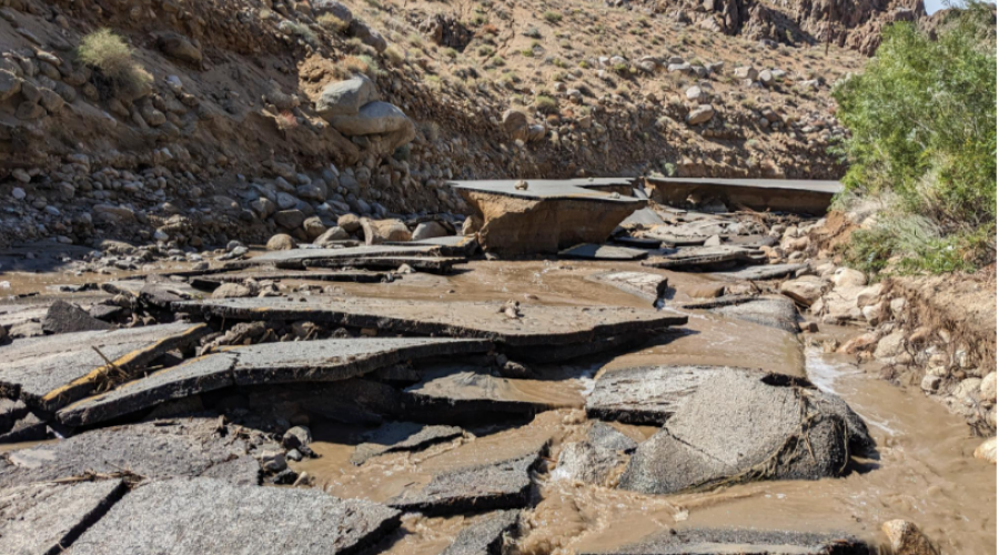 Asphalt road dismantled into pieces by massive flooding.