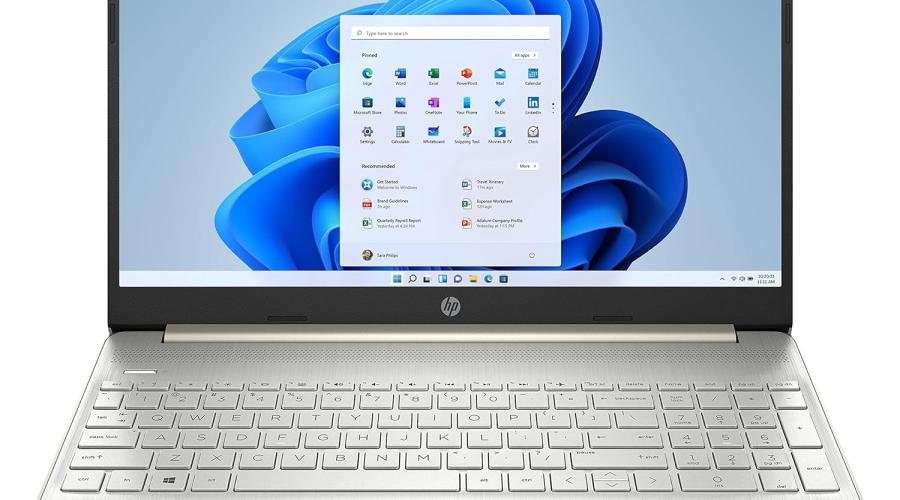 Silver laptop with blue background on screen and a window of applications open