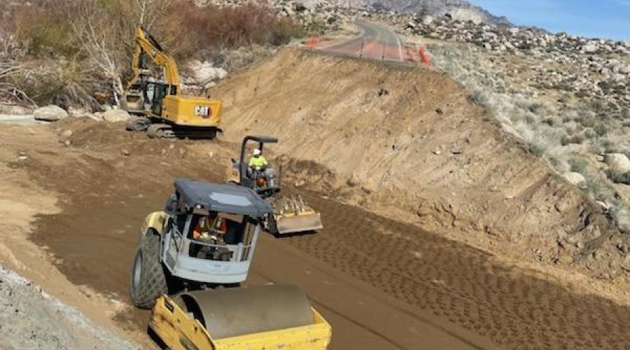 Bulldozers and steamrollers flattening down dirt