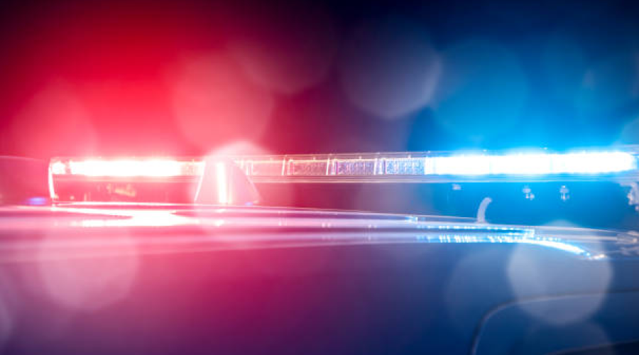 Abstract photo of red and blue emergency lights flashing at night.