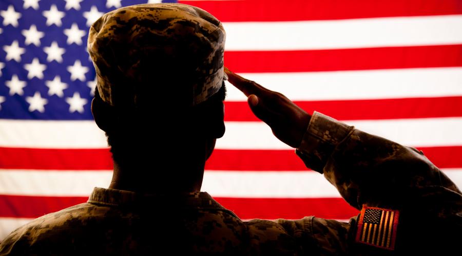 silhouette of soldier saluting the American flag
