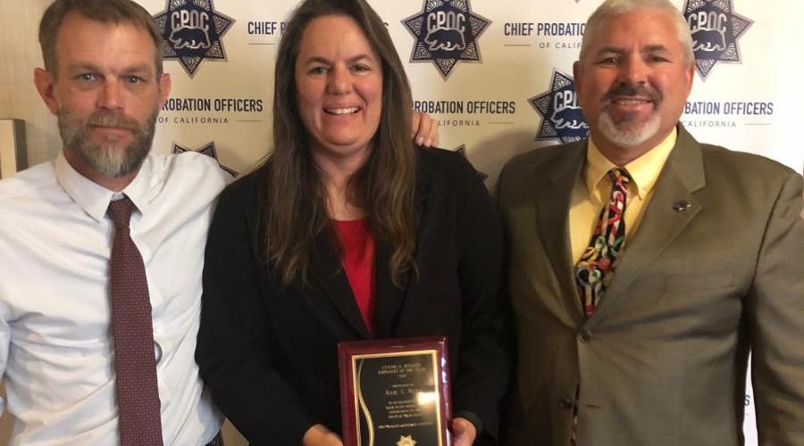 Deputy Chief Probation Officer Jacob Morgan, Officer Julie Weier pictured with CPOC Regional Probation Officer of the Year Award, and Chief Jeff Thomson