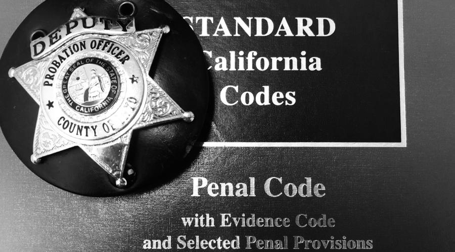 Photo of probation badge with California Penal Code
