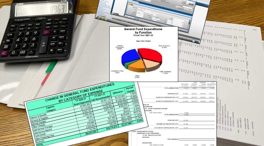 Binder laid open on table with calculator and charts and spreadsheets superimposed on top