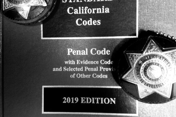 Photograph of Penal Code and Investigator Badges