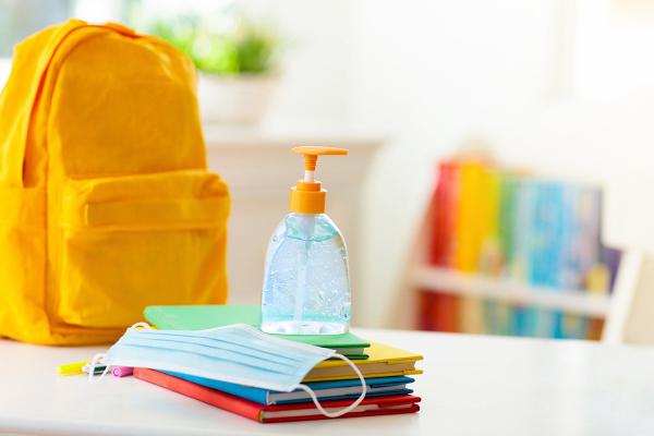 classroom with books, backpack, and hand sanitizer