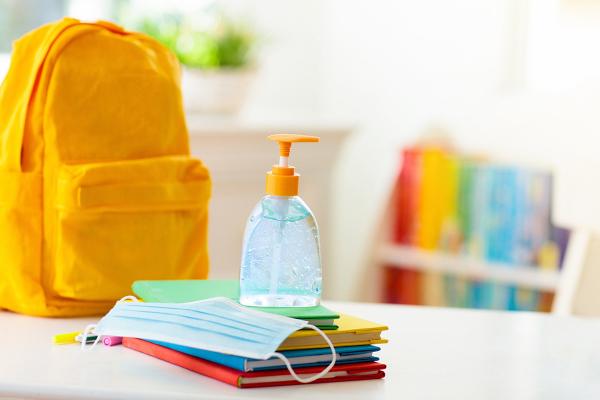 classroom with books, backpack, and hand sanitizer