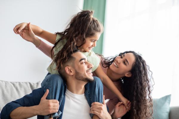 Three people dad daughter and mom laughing